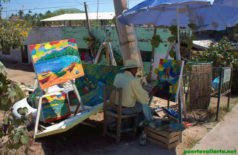 A local artist works by the bridge in Sayulita