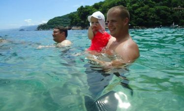 Puerto Vallarta beach during the summer vacation season with safety patrols and ocean conditions in view