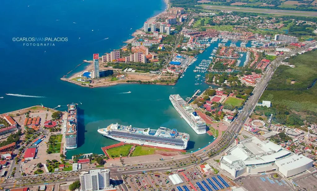 Cruise ships docked at Puerto Vallarta’s maritime terminal, with Marina Vallarta and the Pacific coast visible from above