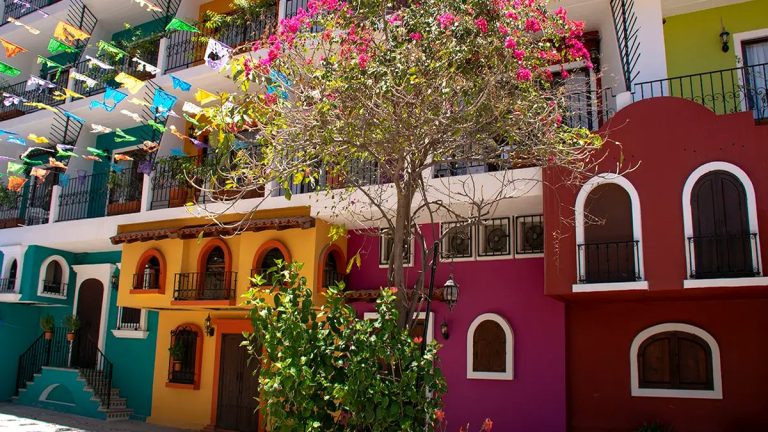 Colorful buildings and papel picado on a Puerto Vallarta street during festival season